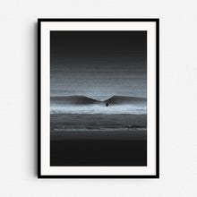 Load image into Gallery viewer, A high-contrast black-and-white photo of a surfer facing a breaking wave. Framed in black wood for bold, dramatic wall art.
