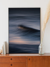 Load image into Gallery viewer, Soft purple streaks of light contrast with a dramatic wave. Poster framed in black aluminum for modern abstract artwork.
