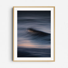 Load image into Gallery viewer, Long exposure of a powerful wave in Scheveningen with soft purple shades. Framed in natural wood for an organic, serene touch.
