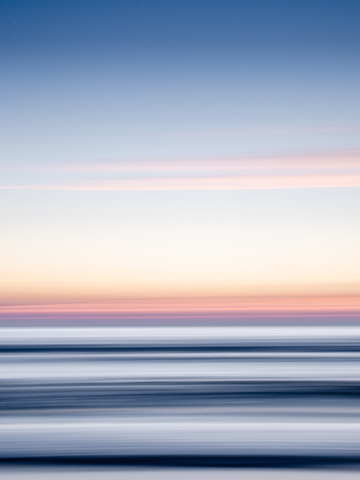 Abstract North Sea seascape with sunset hues, featuring smooth transitions in light and dark. A tranquil, vibrant image.