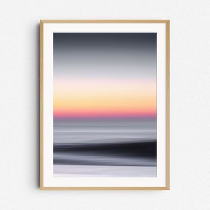 Sunset over the North Sea with orange and grey tones. Abstract, framed in natural wood. Perfect for minimalist coastal interiors.