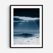 Load image into Gallery viewer, A dramatic surf landscape with sunlight breaking through clouds over the North Sea. Framed in black wood for modern wall art.
