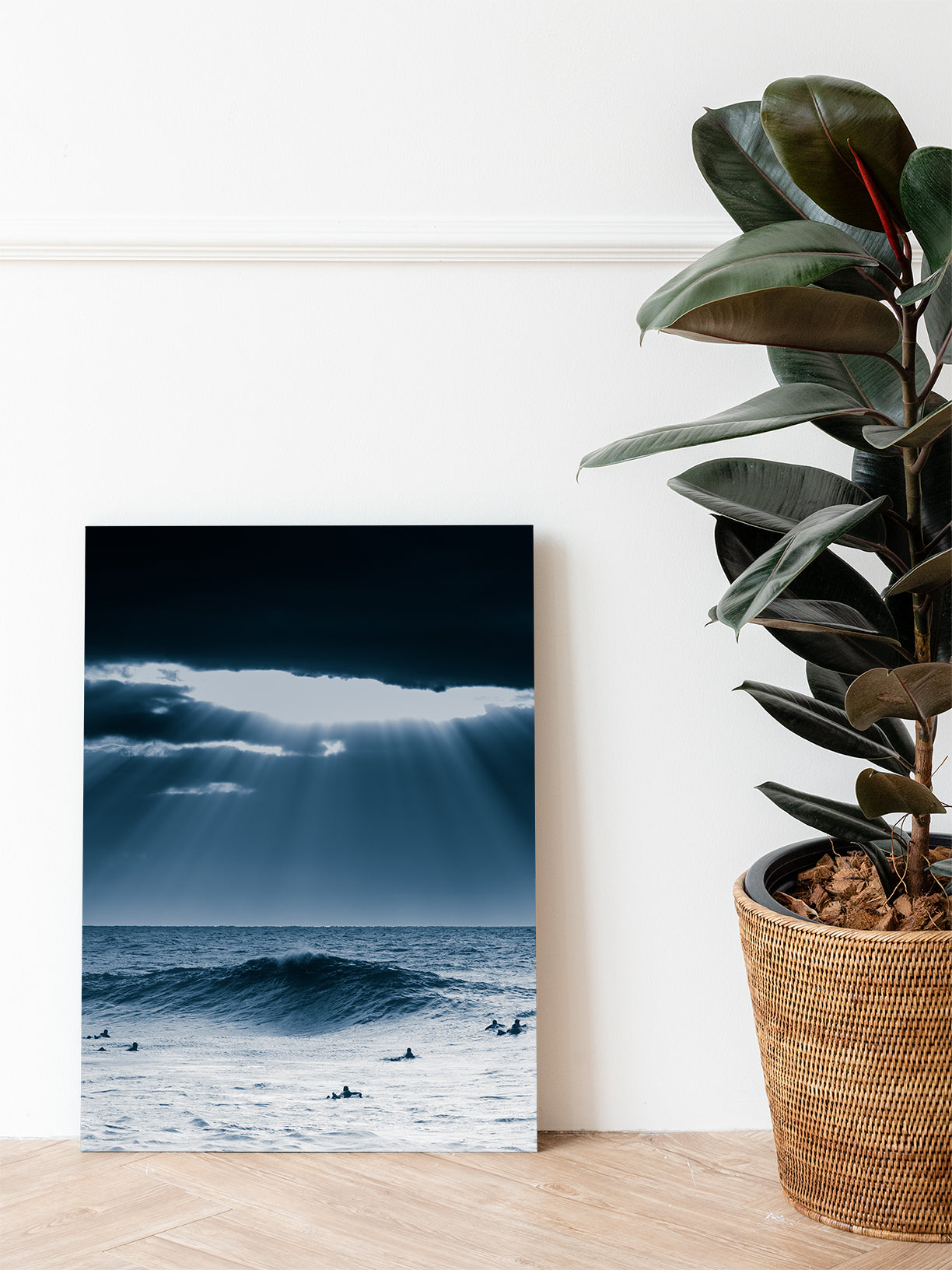 A classic surf scene – sunlight streams through heavy clouds over surfers in the North Sea. Printed on Dibond for long-lasting wall art.