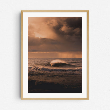 Colorful photo of a large wave breaking in Scheveningen during sunset.