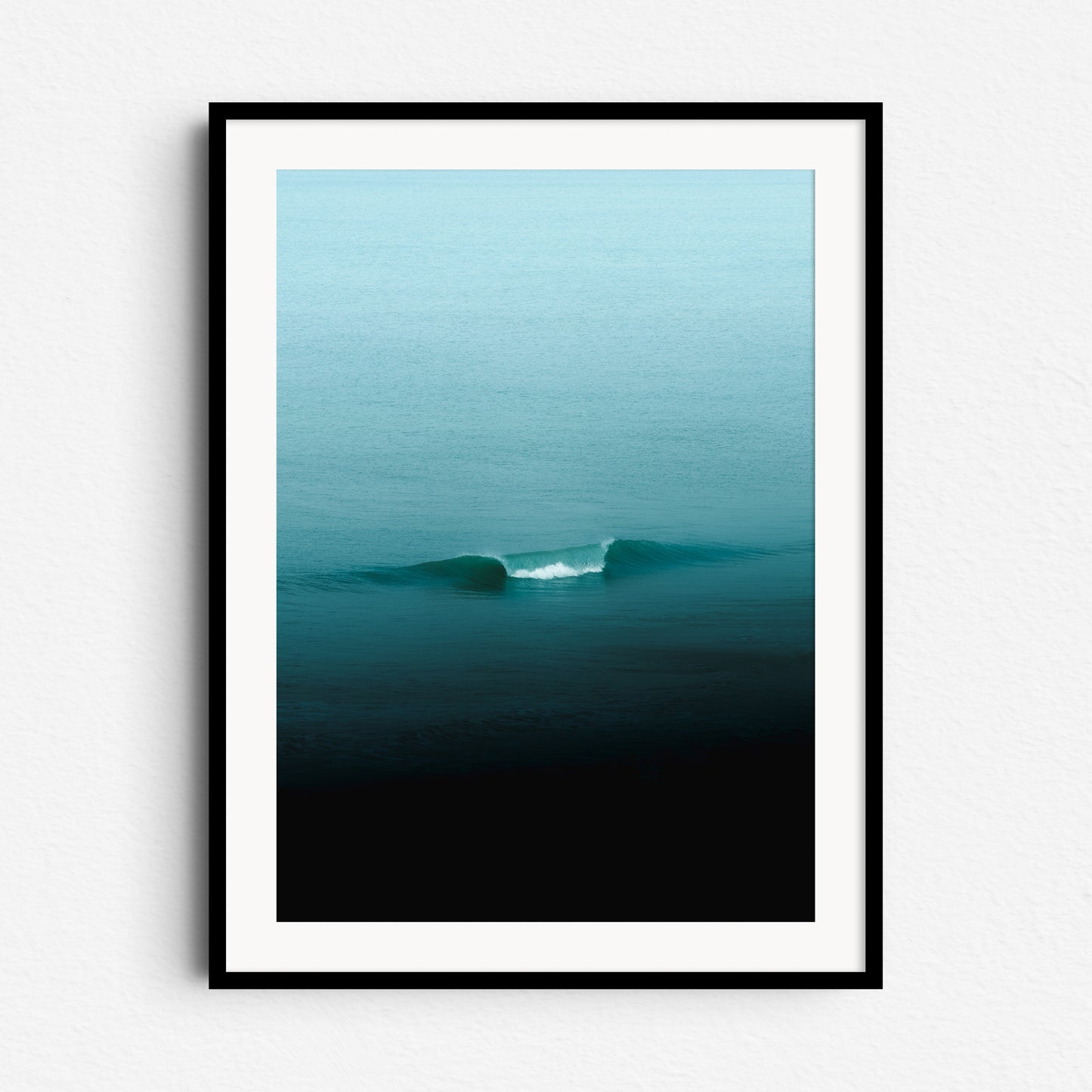 Turquoise wave on the North Sea, framed in black wood, minimalist wall art from The Hague.