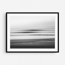 Load image into Gallery viewer, Black and white long exposure photo of breaking North Sea waves, framed in black wood. A dramatic piece for modern coastal wall decor.
