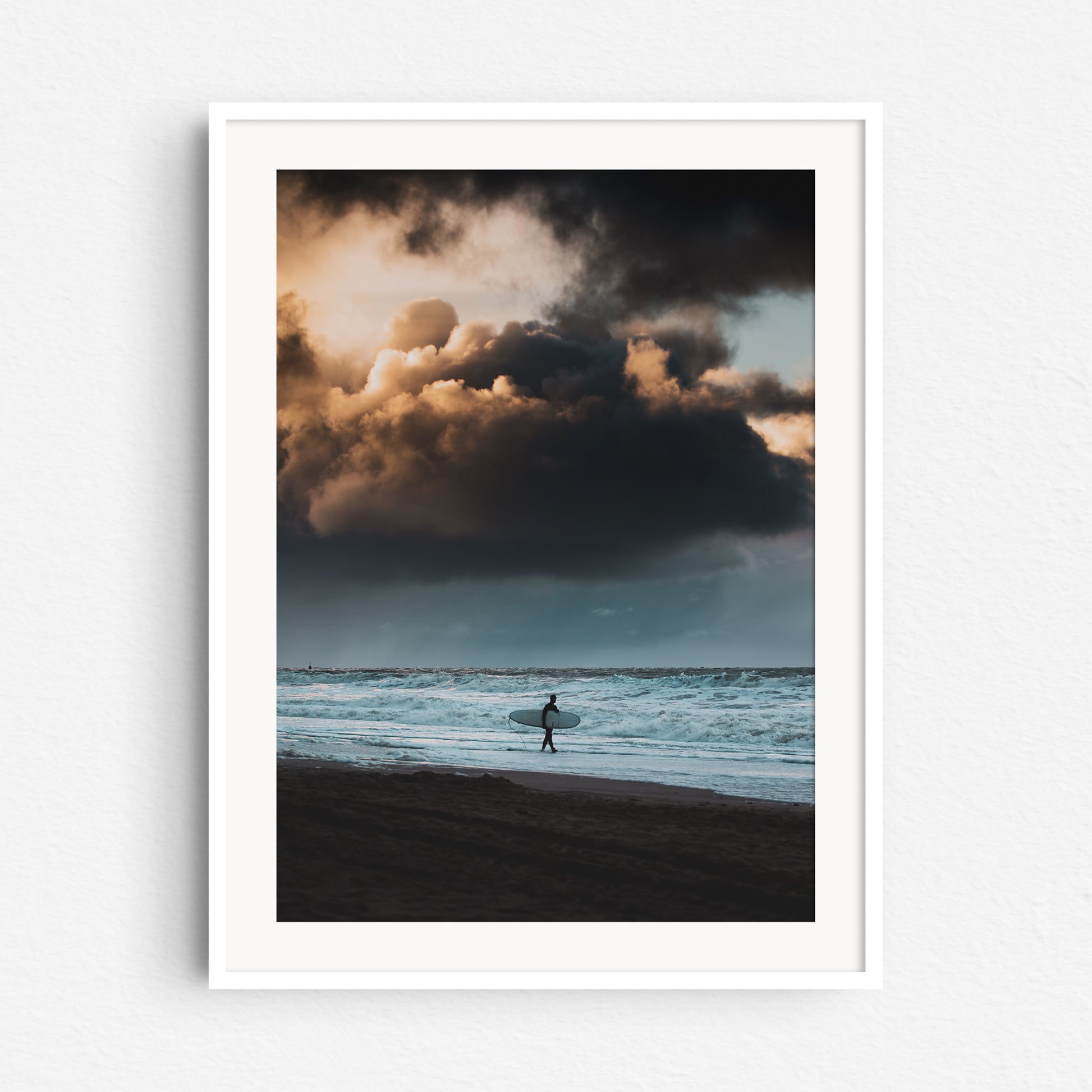 Heavy skies on the Dutch coastline. Surf photography in a white wooden frame.